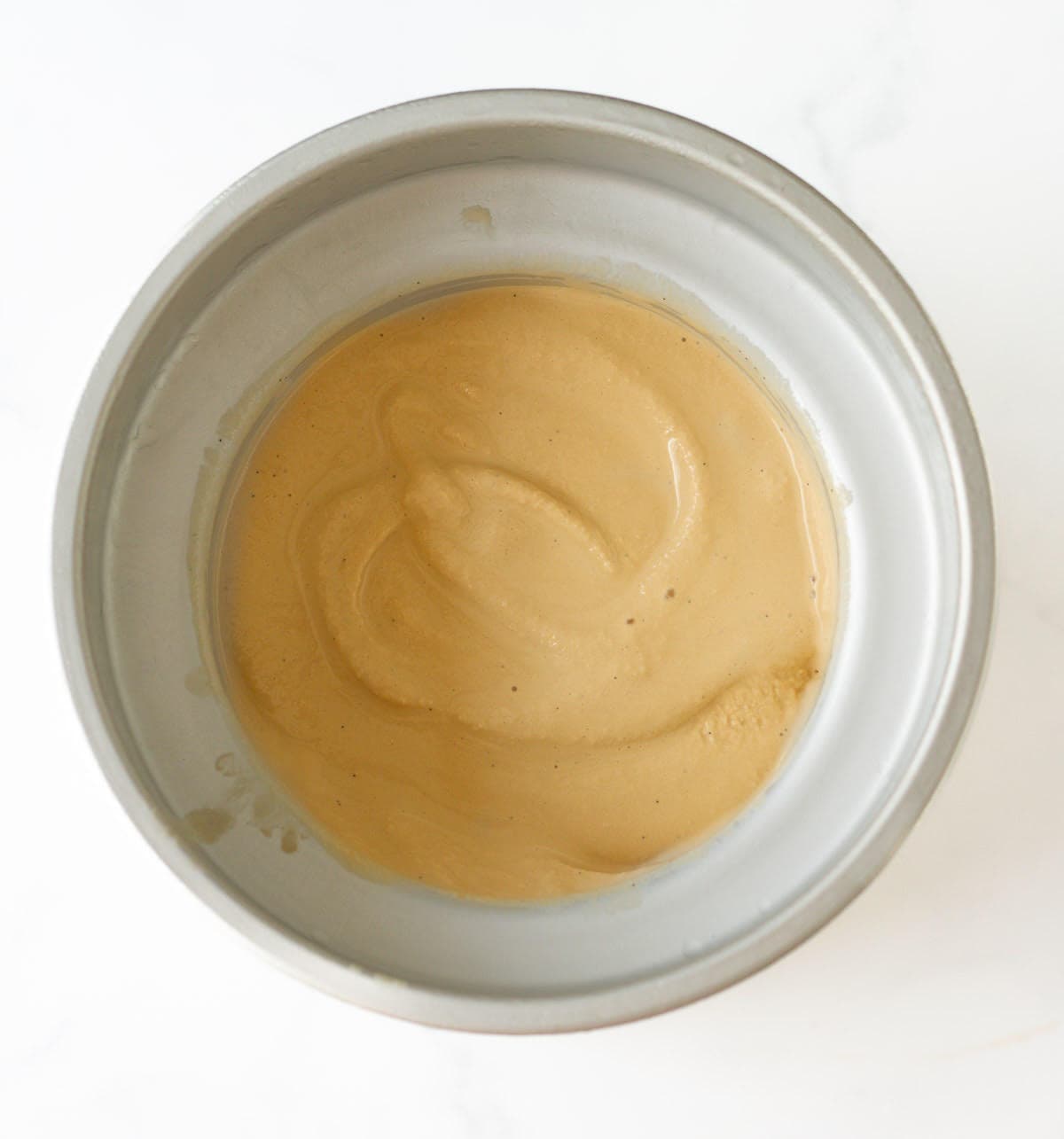 Soft coffee ice cream in ice maker canister.