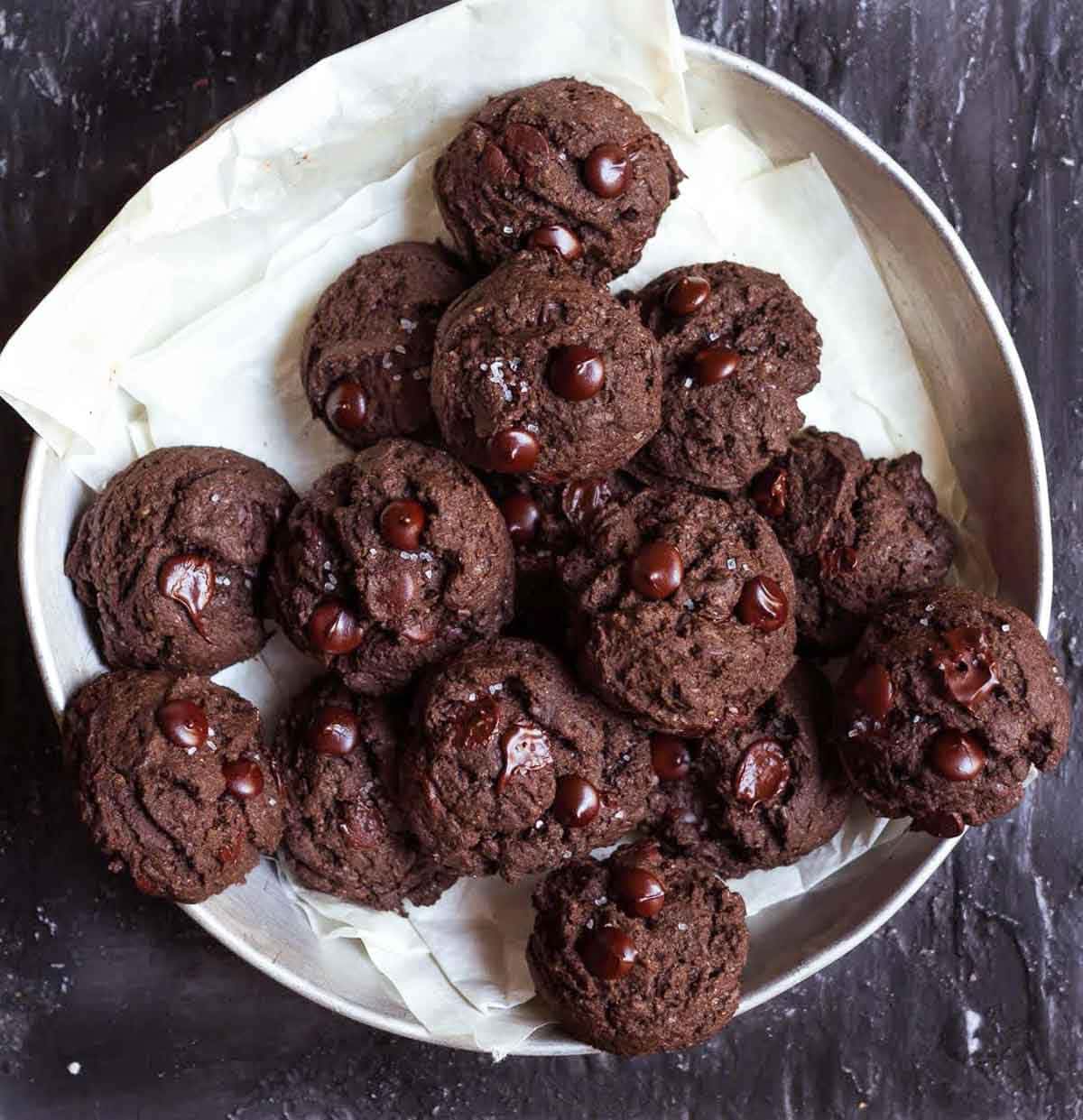 A platter full of double chocolate chip cookies.