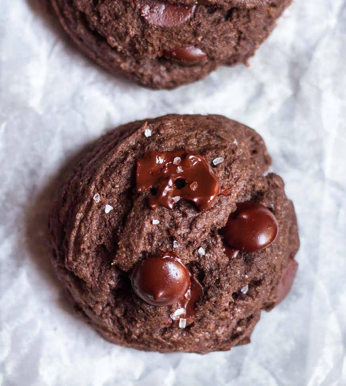 Chocolate chip cookie on parchment paper.