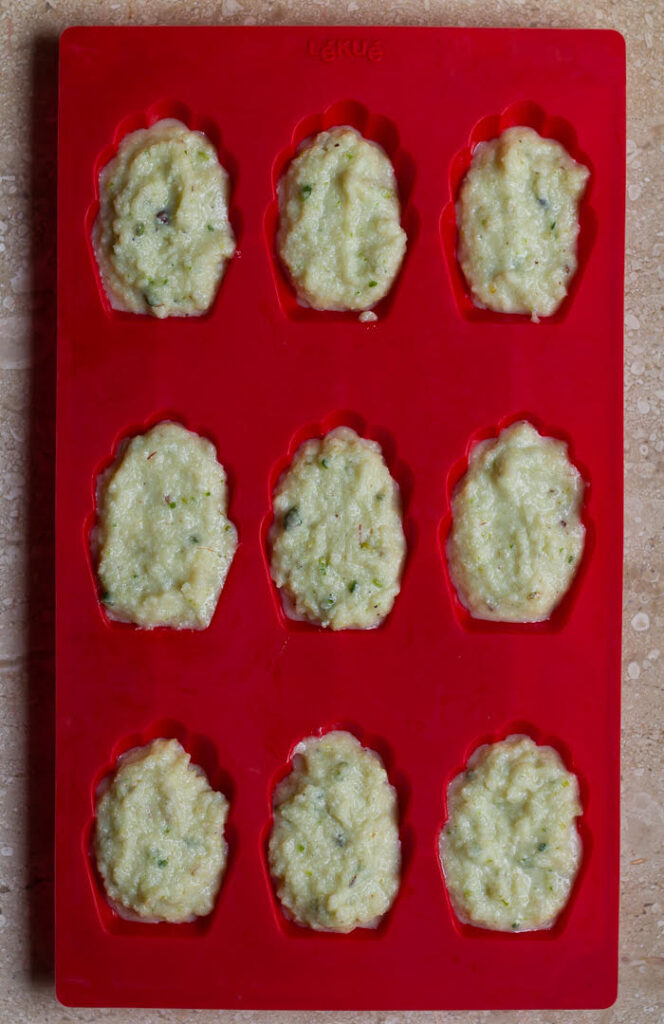 Ready to bake Cardamom Pistachio Madeleines | Easy Eggless Madeleine Recipe