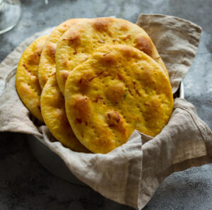 Sheermal breads in a napkin lined basket.