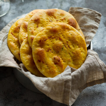 Sheermal breads in a napkin lined basket.