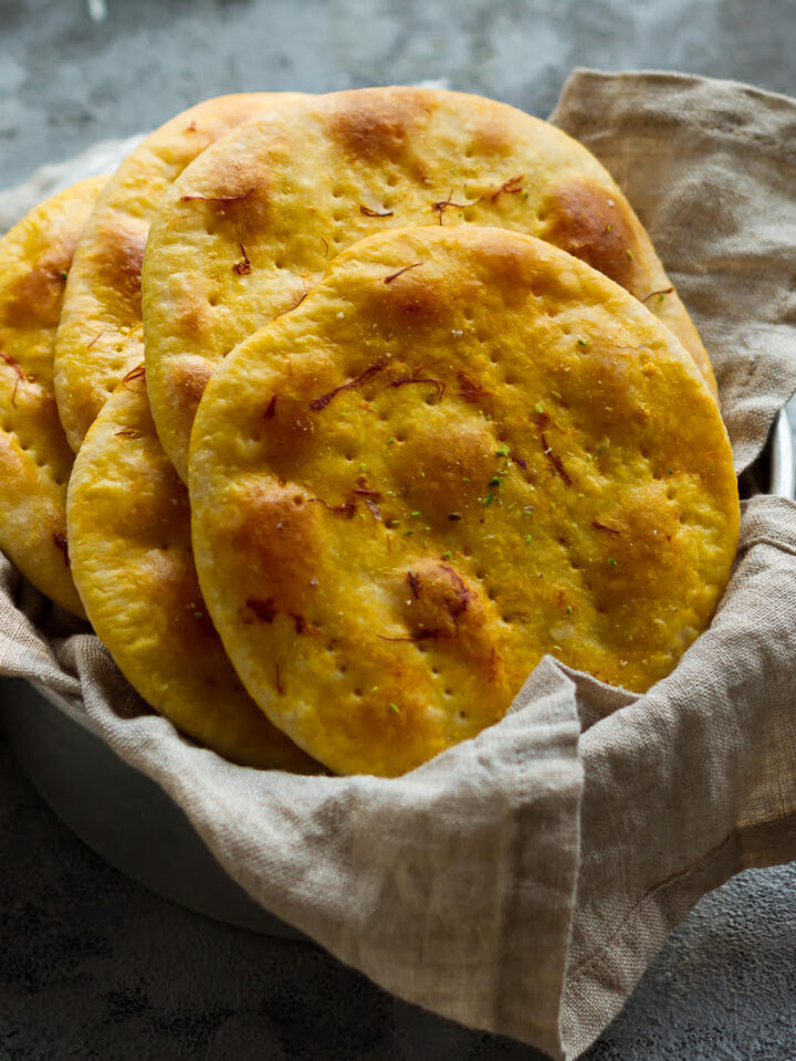 Sheermal breads in a napkin lined basket.