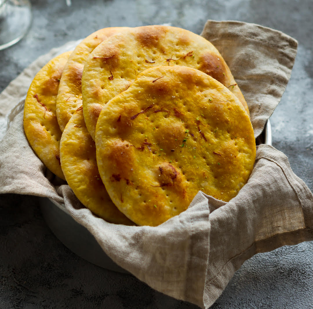 Sheermal breads in a napkin lined basket.