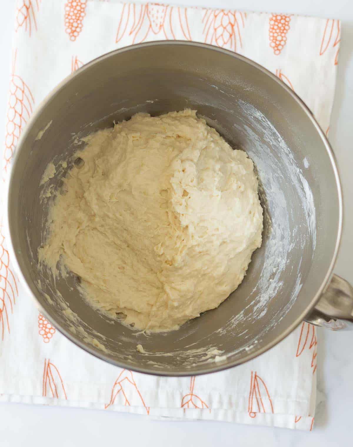 A rough dough in the bowl of a stand mixer.
