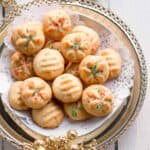 Cookies with white, red, and green sprinkles on a tray.