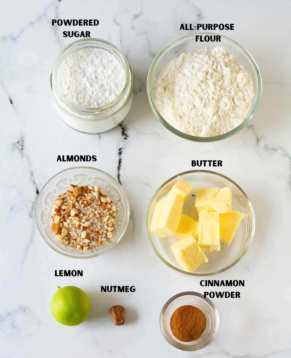 Labelled ingredients for making lemon crescent cookies.