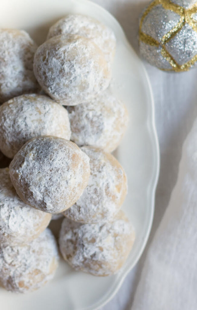 closeup photo of a snowball cookies dusted with powdered sugar.