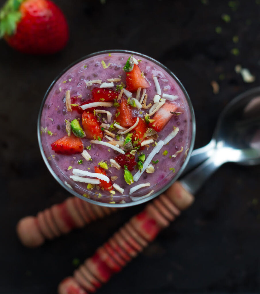 Strawberry Chia Pudding topped with toasted coconut, strawberries and pistachios.