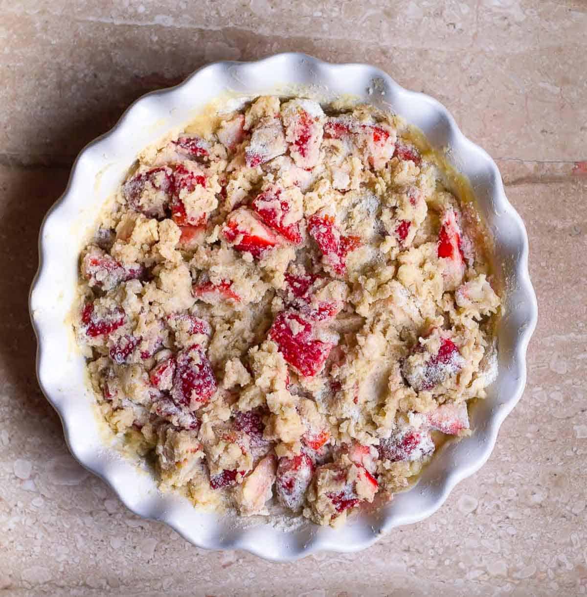 strawberry cake batter all mixed up roughly in a baking pan.