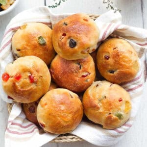 buns with tutti frutti in a napkin lined basket.