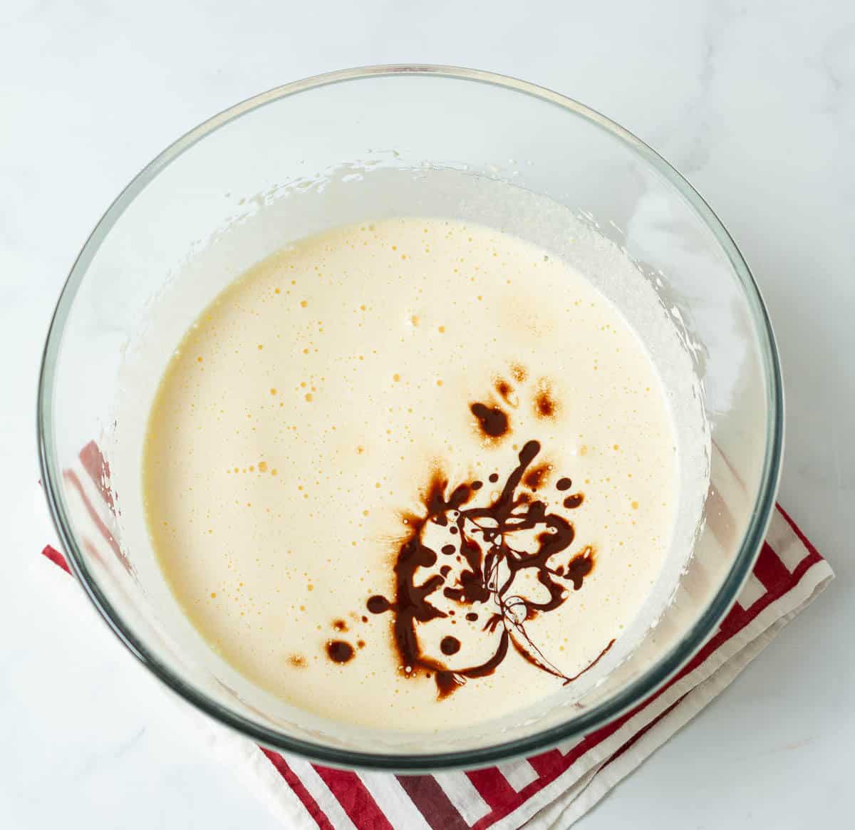 Vanilla extract on top of eggs and sugar mixture.
