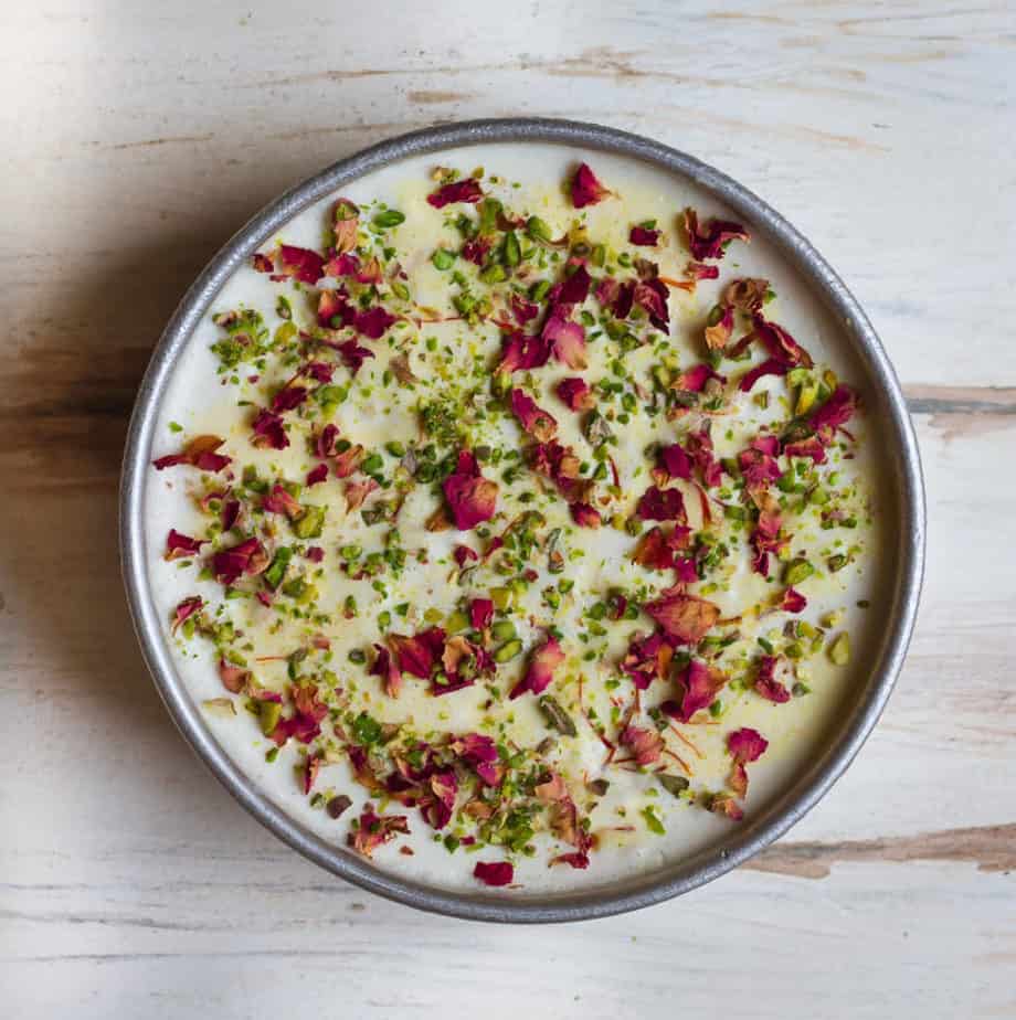 Topping the semi frozen ice cream with pistachios and rose petals |No-Churn Thandai Ice Cream | Easy Thandai Ice Cream Recipe