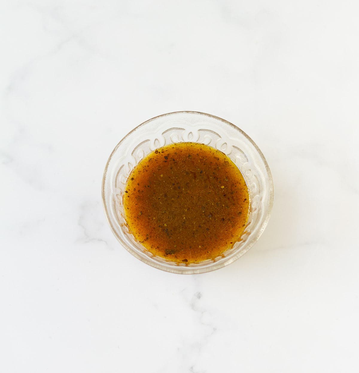Salad dressing in a small bowl.