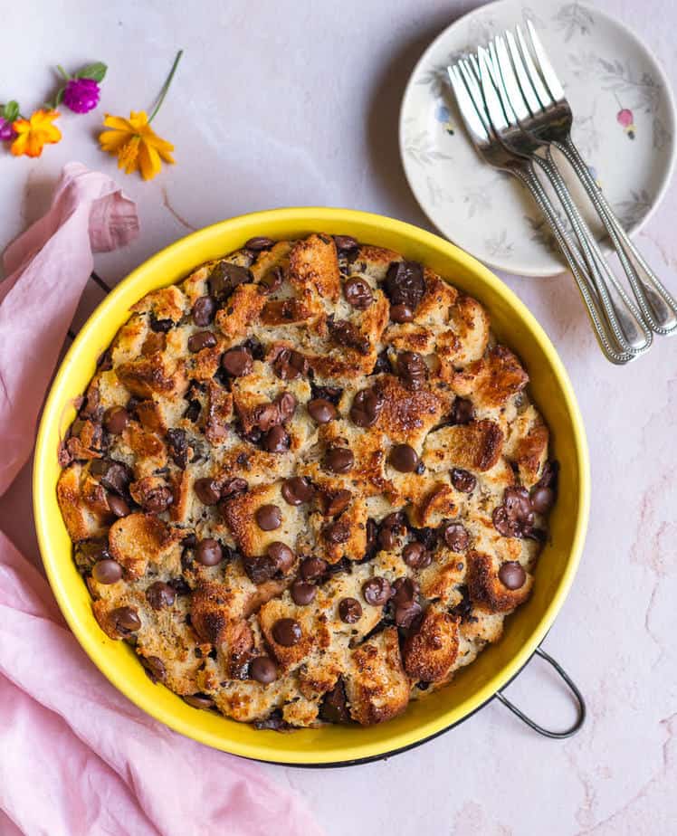 Chocolate Chip Bread Pudding in a yellow round dish with forks on the side.