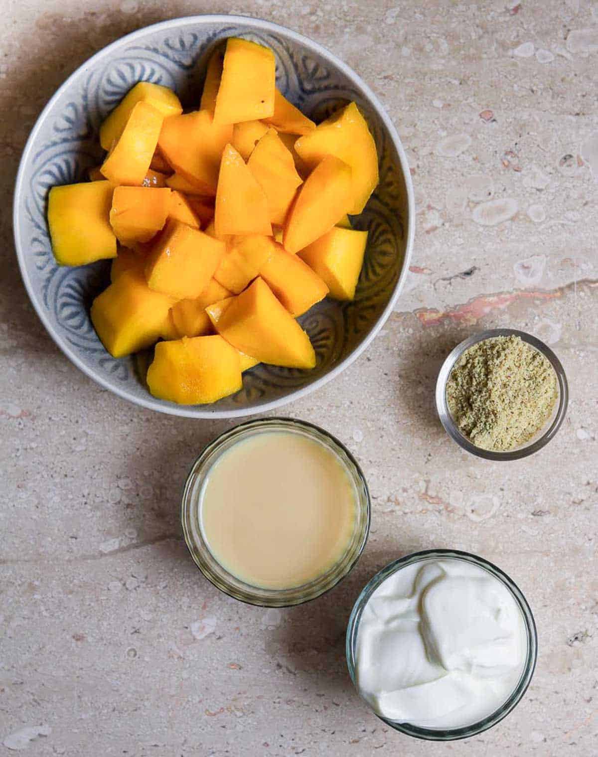 Ingredients for making mango thandai popsicles.