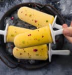 3 popsicles on a tray and 1 popsicle held on top.