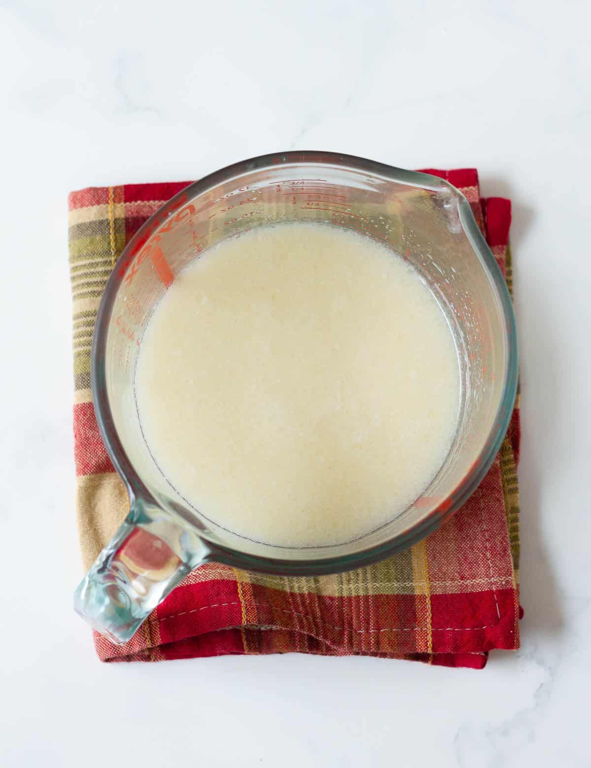 Wet ingredients for muffin batter in a measuring cup.