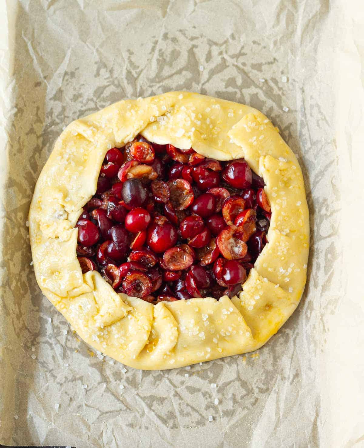 Edges of pastry folded over the cherry filling and brushed with egg wash.
