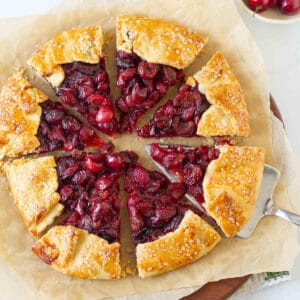 Cherry galette cut into 8 slices with a pie server.