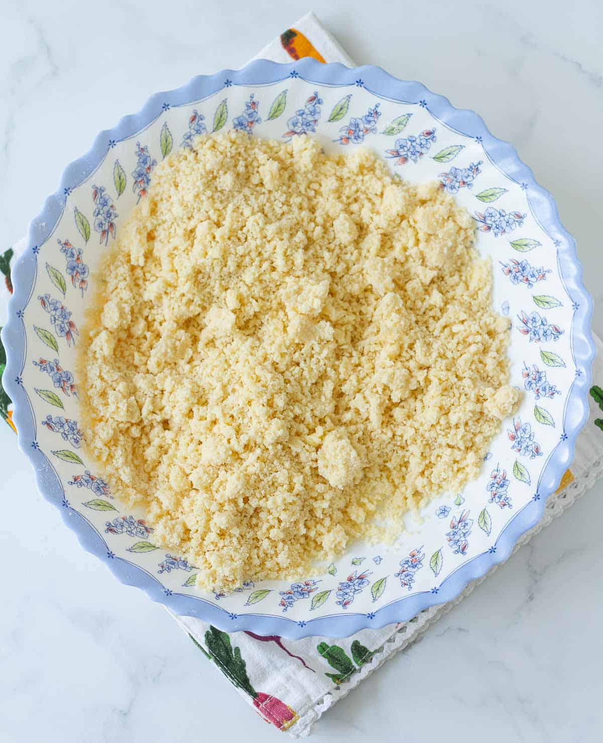 Crumbled flour and butter mixture for pie crust in a bowl.