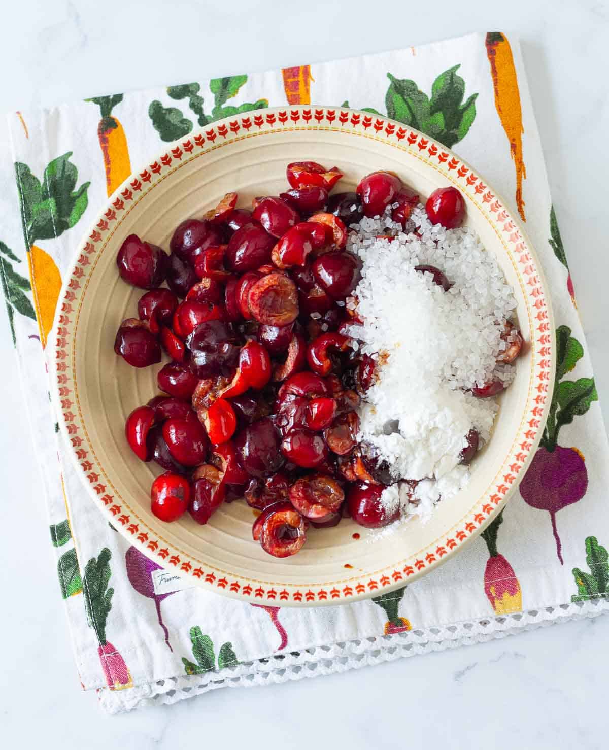 Cherries, sugar, cornstarch, and vanilla extract in a bowl.