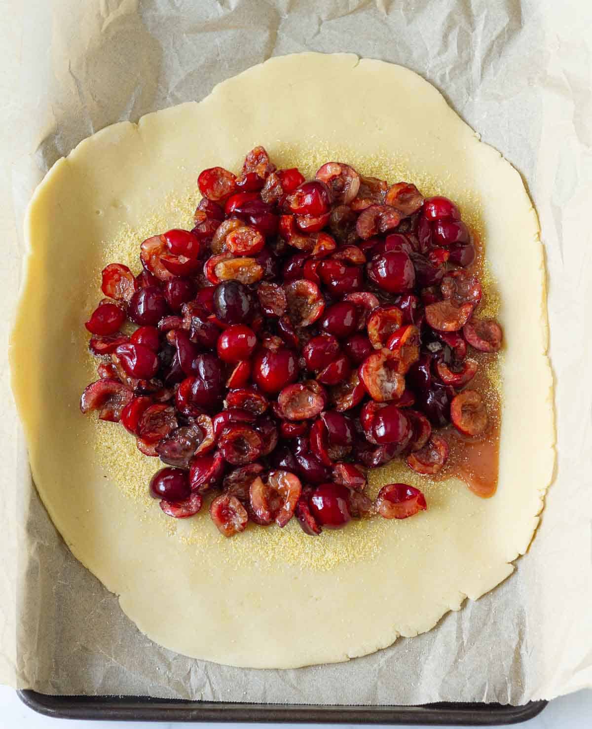 Cherry filling on top of rolled out pastry dough.