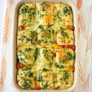 Baked garlic cheese bread in a baking dish.