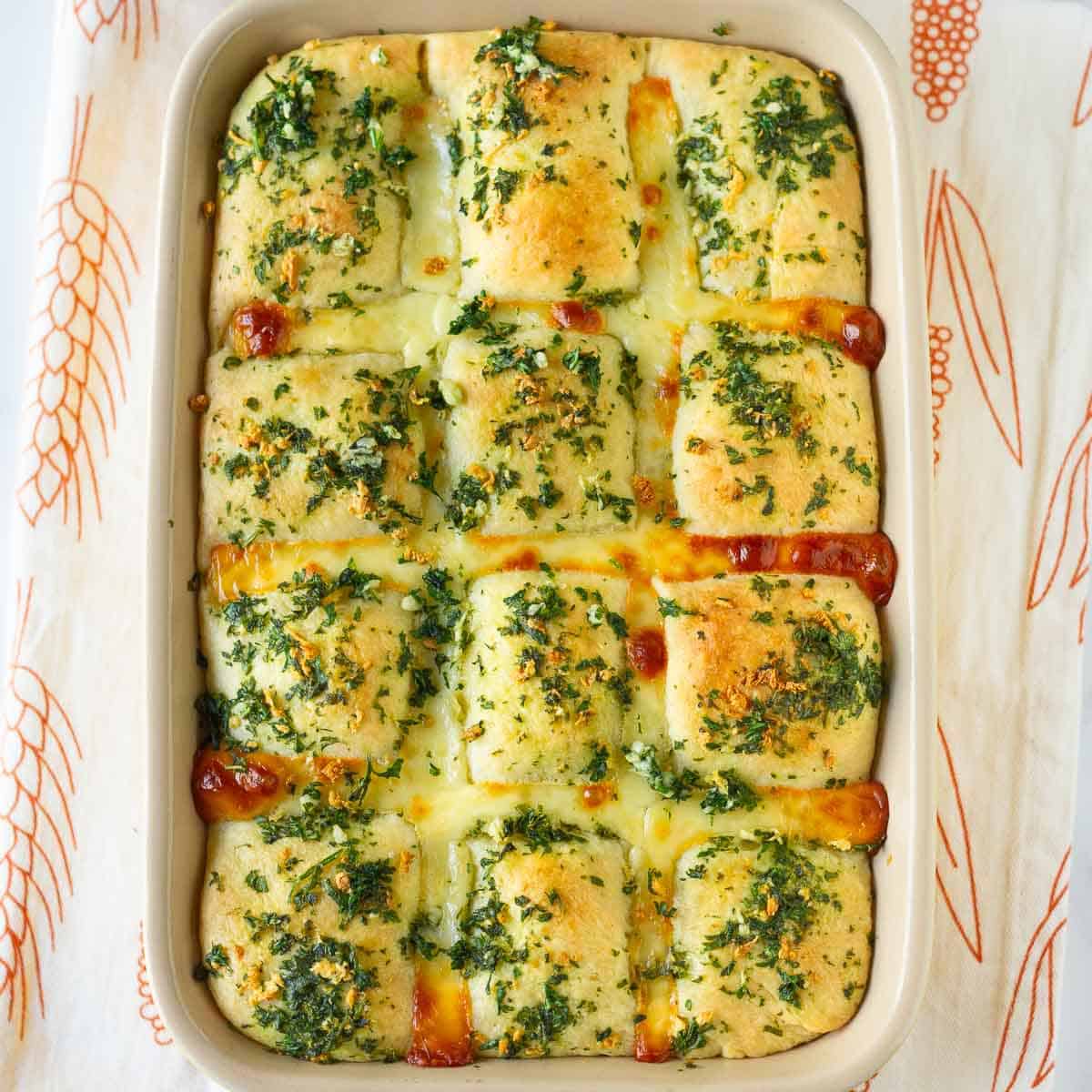 Baked garlic cheese bread in a baking dish.