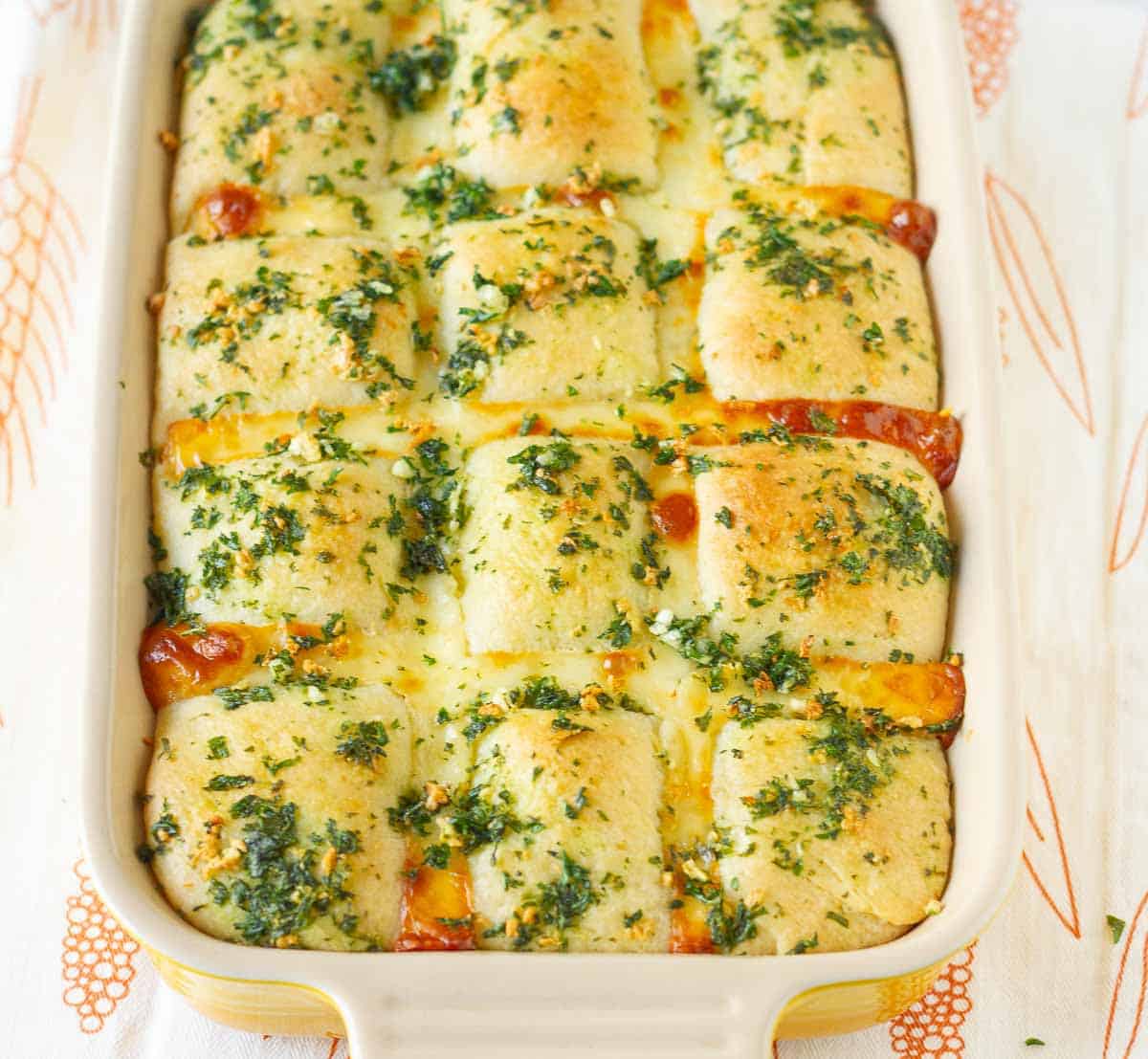 Baked garlic cheese bread in a baking dish.