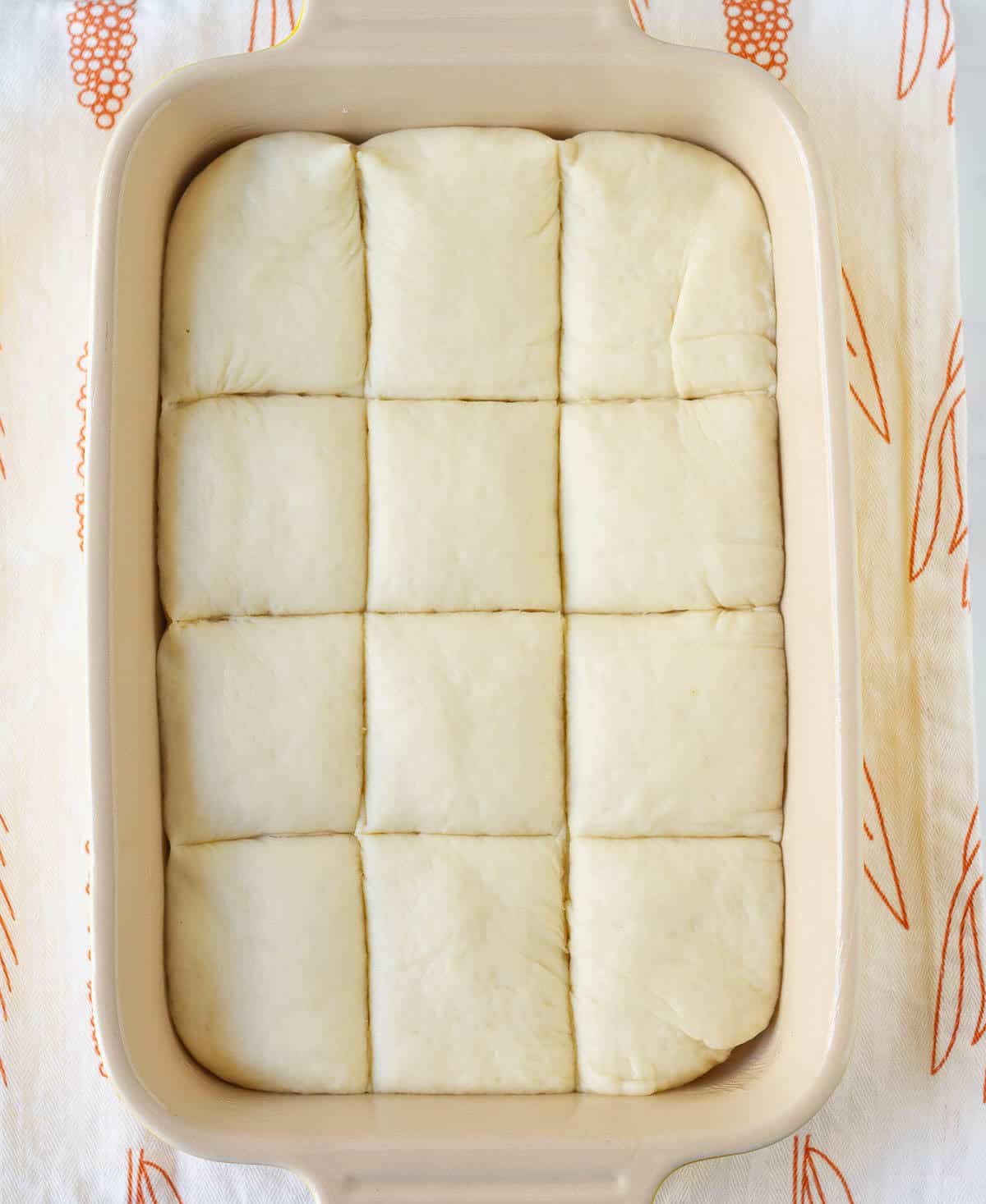 Rolled out, scored dough in a baking dish.