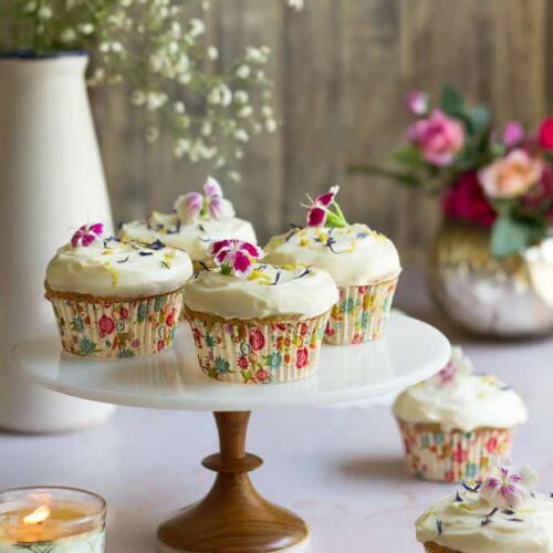Lemon Poppyseed Cupcakes on a cake stand.