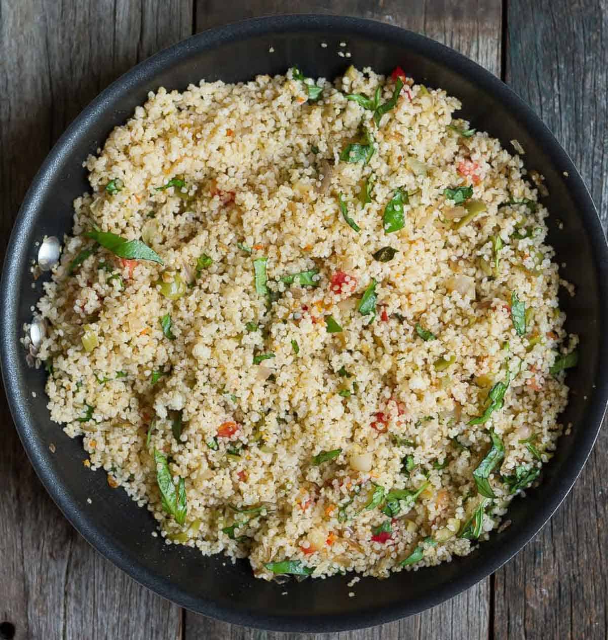 Millet stuffing mixture in a black bowl.