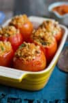 Baked stuffed tomatoes in a baking dish.