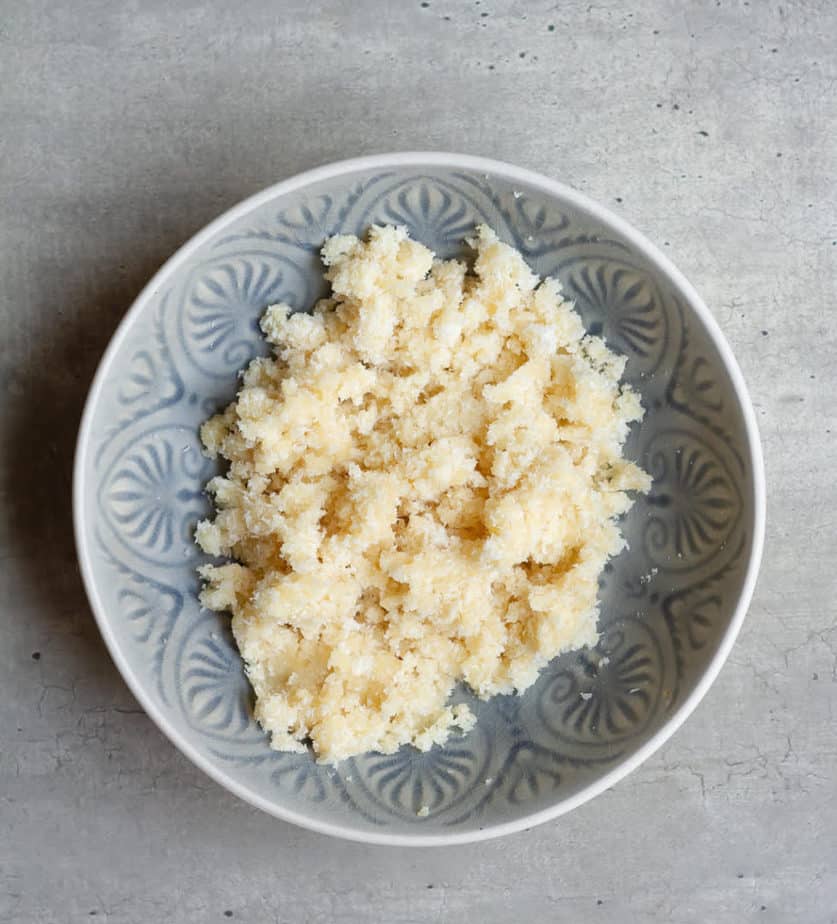 marzipan and coconut filling in a blue bowl.
