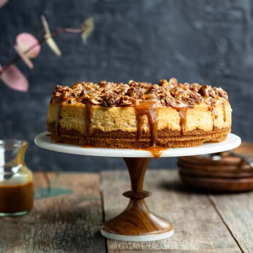Apple Crumble Cheesecake on a cake stand.