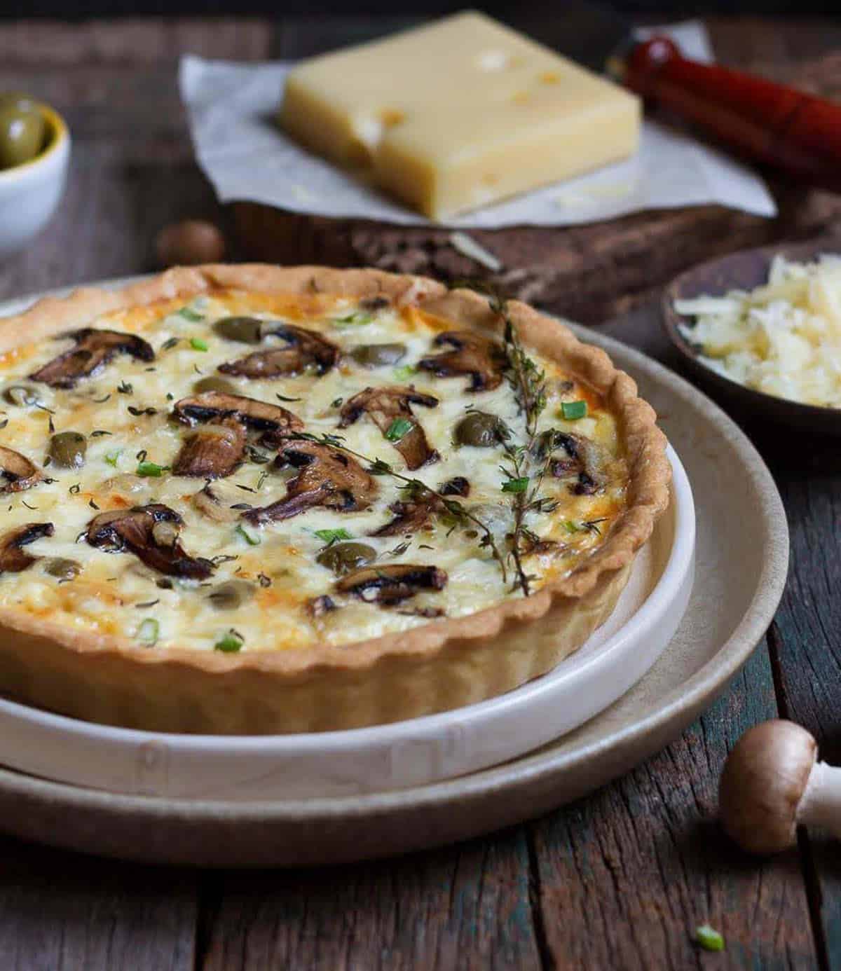 baked mushroom quiche on a serving plate.