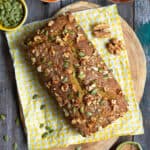 Pumpkin bread on a yellow napkin on a wooden board.