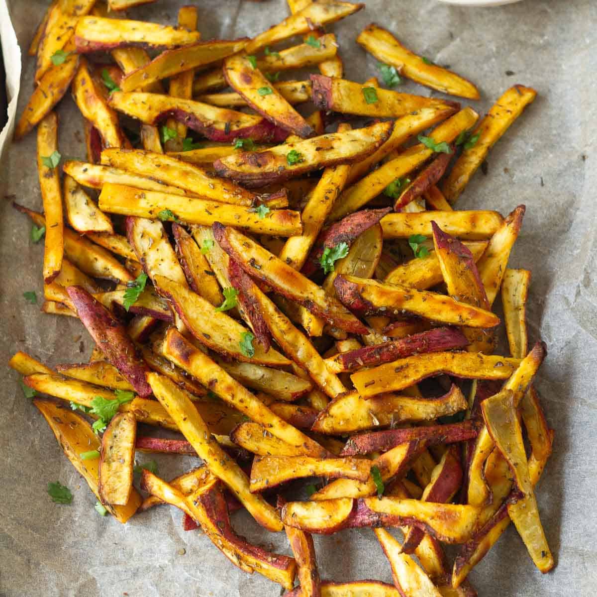 oven-baked sweet potato slices on parchment paper.