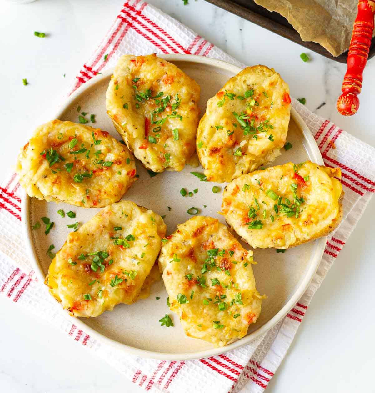 Baked loaded potatoes on a plate.