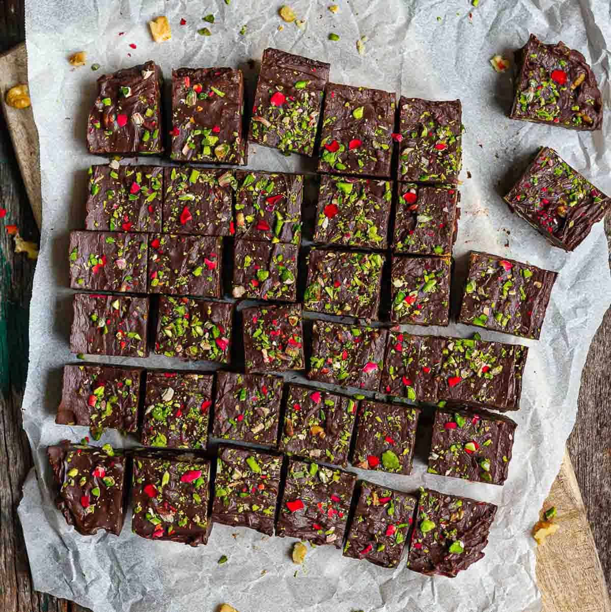 chocolate fudge cut into squares on parchment paper.