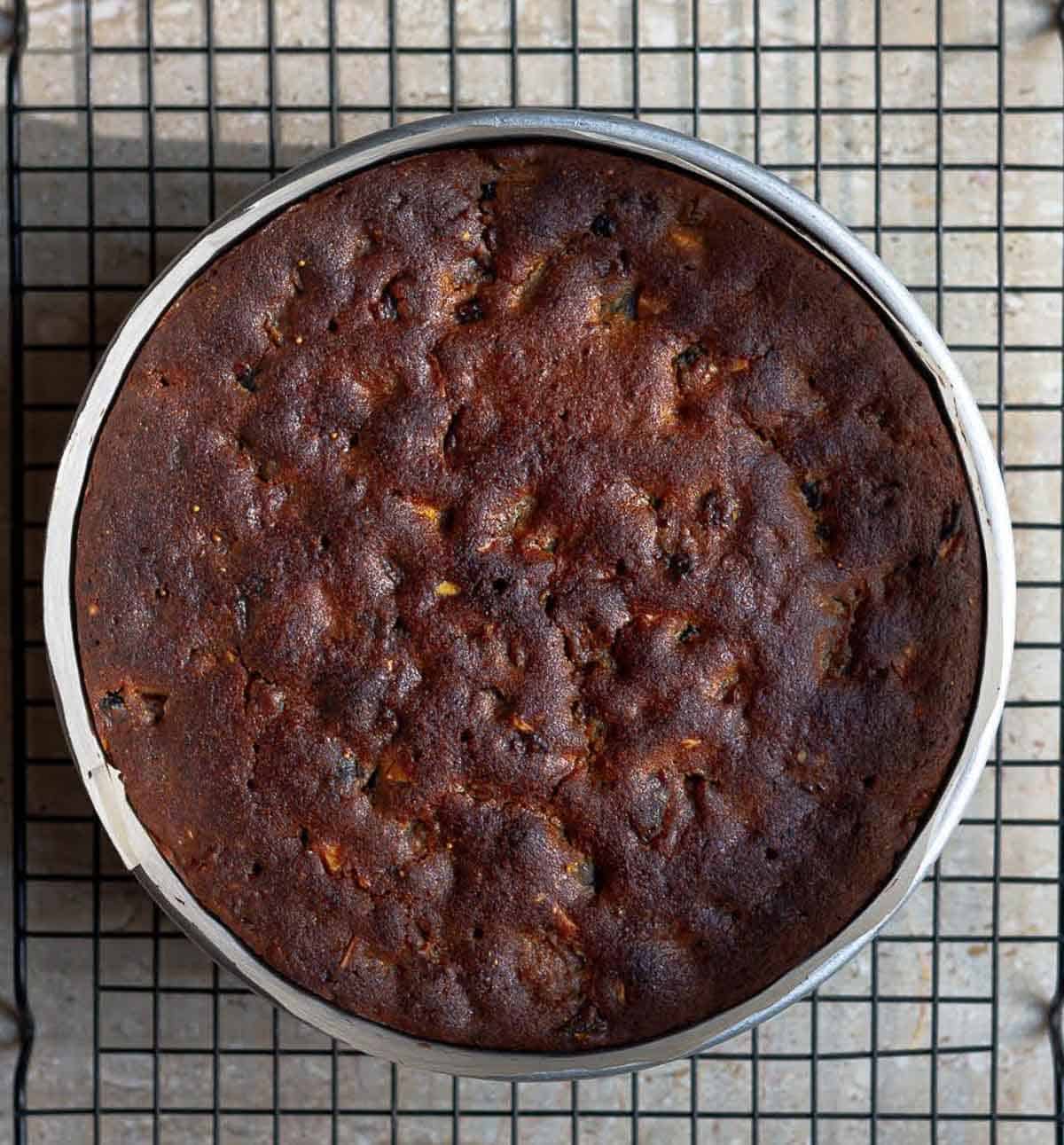 baked christmas cake with rum in a round cake tin.