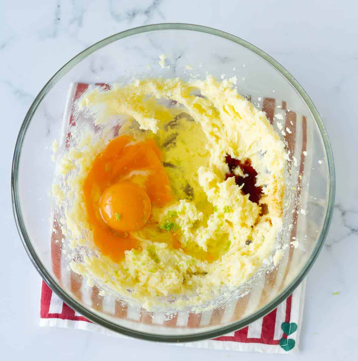 creamed butter and sugar with eggs, lemon zest and vanilla extract on top.