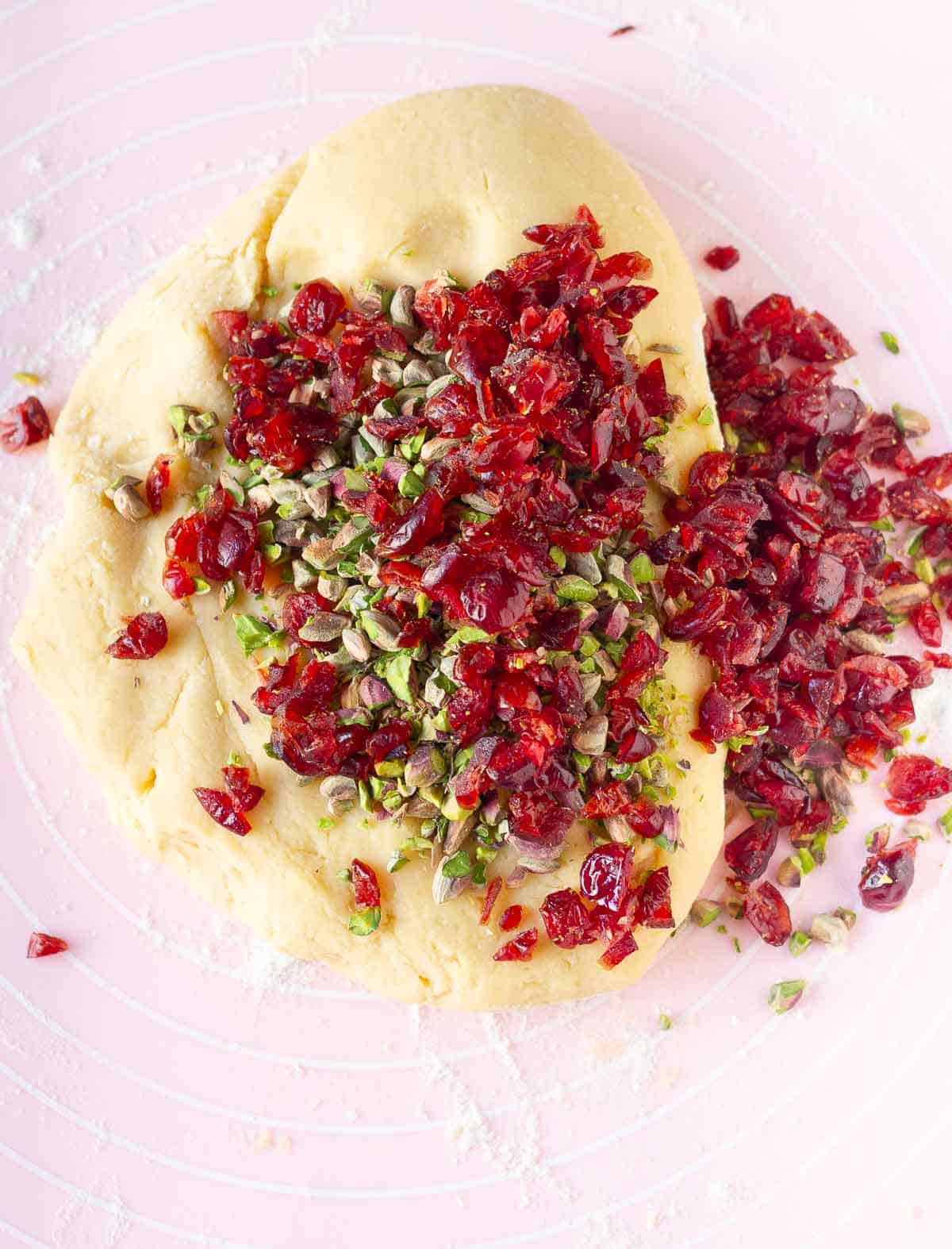dried cranberries and pistachios on top of the dough.