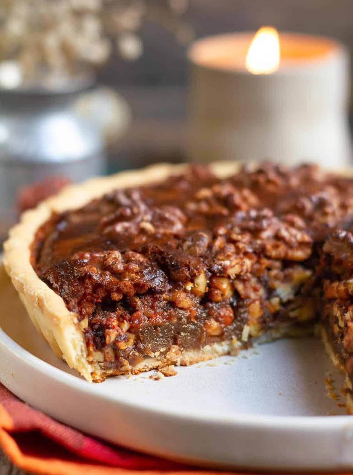 cross section of walnut pie on a serving platter.