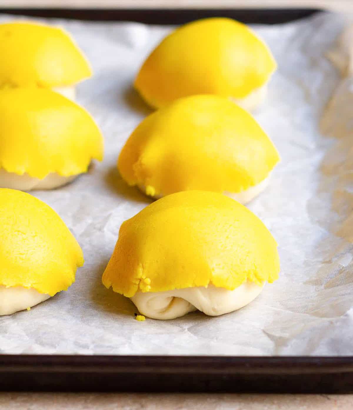 Dough balls covered with discs of yellow dough.