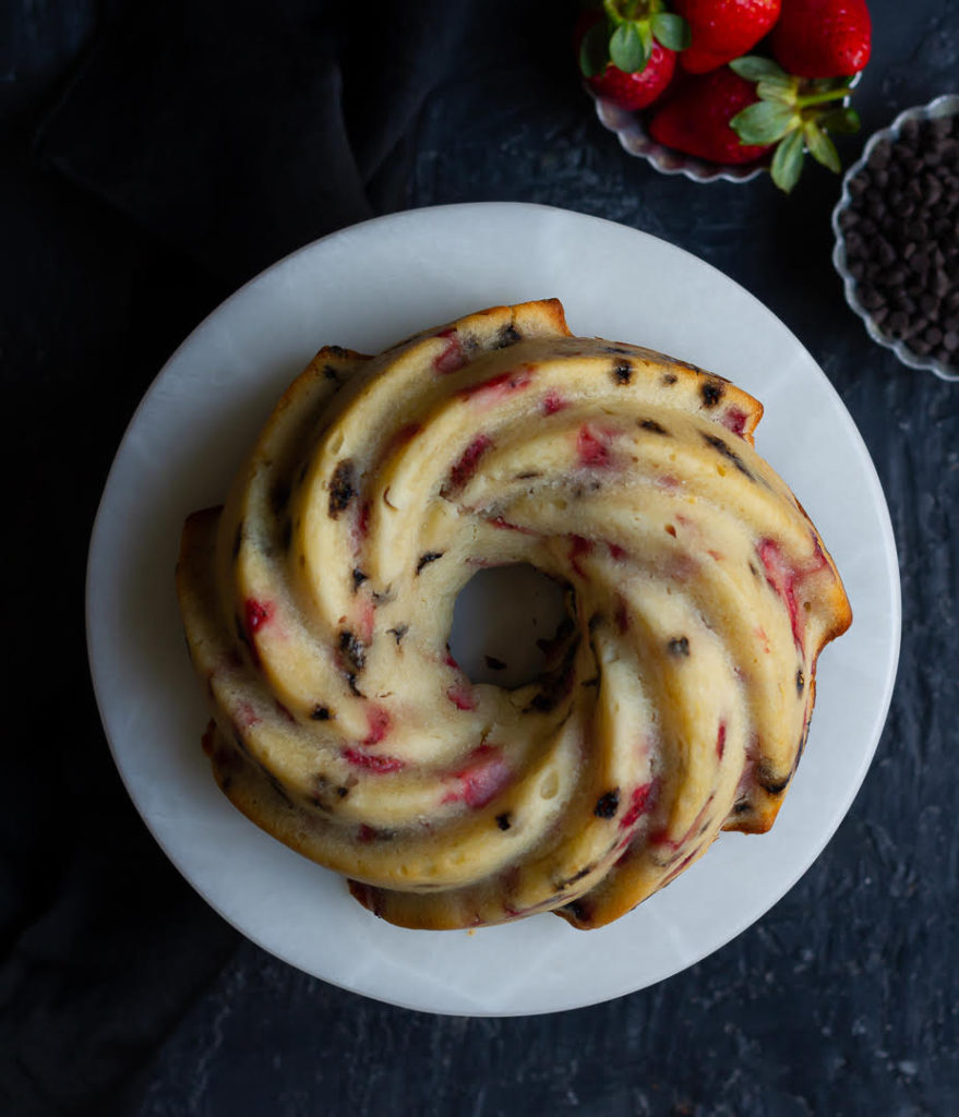 Strawberry Cream Cheese Pound Cake on a cake stand.