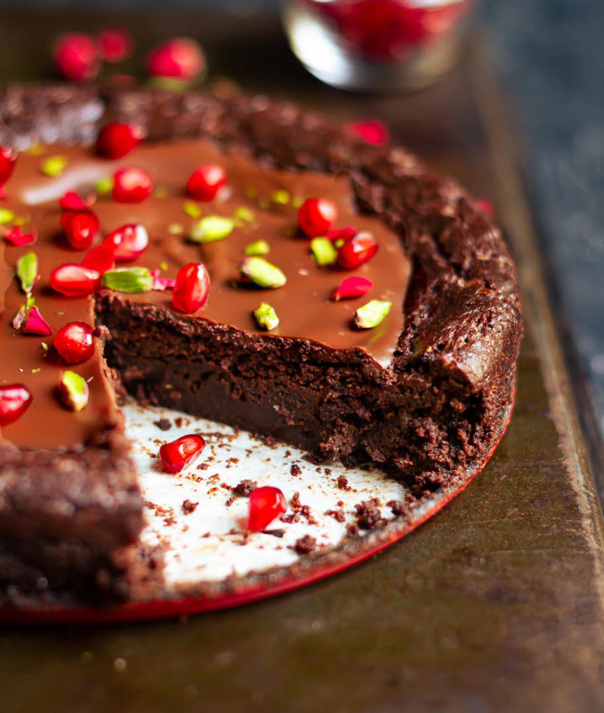 Chocolate cake with a slice taken out to show the gooey inside.