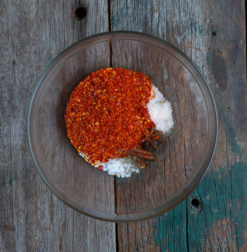 Dry ingredients for making chili oil in a glass bowl.