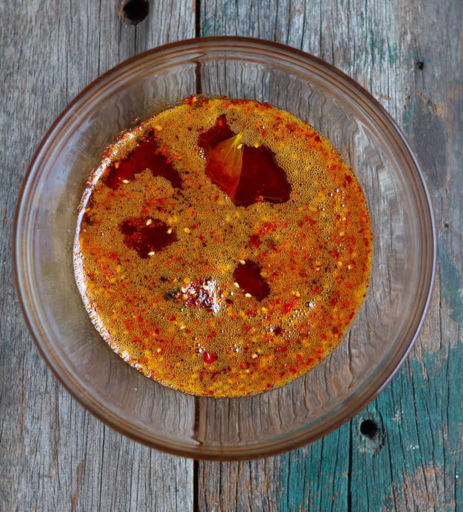 hot oil on top of the dry ingredients in a glass bowl.